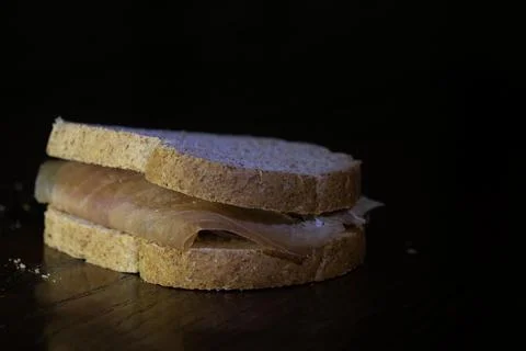Prosciutto sandwich on dark background Stock Photos