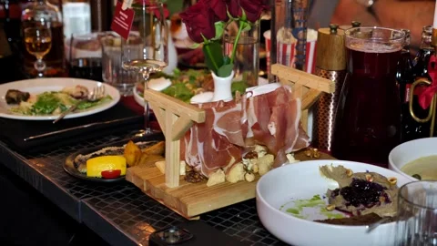 Prosciutto served on a creative wooden stand on a restaurant holiday table. Stock Footage 340533145