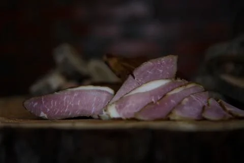 Prosciutto Served on a Rustic Wooden Surface. Smoked Cured Ham Stock Photos