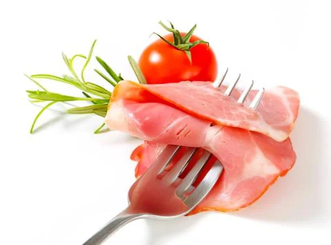 Prosciutto slices on fork with cherry tomatoes Stock Photos