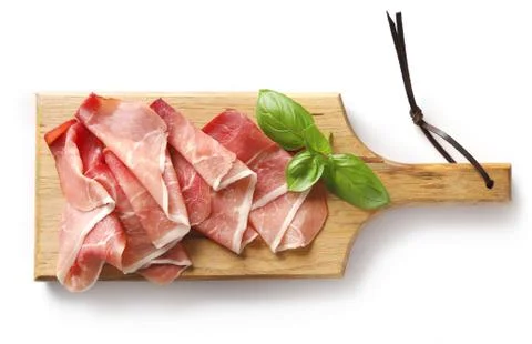 Prosciutto on wooden cutting board Stock Photos
