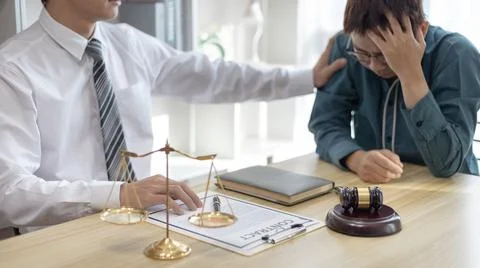 Prosecutor or lawyer comforts a client who is worried about a fraudulent busi Stock Photos