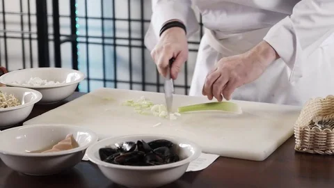 Proseffional chef hands is cutting celery on his own modern kitchen in slow Stock Footage 73211918