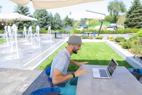 Prosperous sales manager reading documents, using laptop at tabl Фото