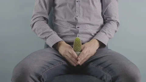 Prostate problems Men sitting on chair in studio show pain Symptoms Video stock 230152264