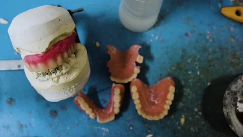 Prosthetic Laboratory Workplace with False Teeth in the Table Stock Footage 146290578