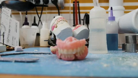 Prosthetic Laboratory Workplace with False Teeth in the Table Stock Footage 146290665