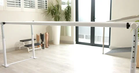 Prosthetic legs displayed in lab with parallel bars for rehabilitation therapy Video stock 298144546