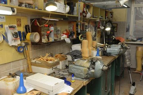 Prosthetic workshop interior with workbench bench vices tools tape hammer box 스톡 사진