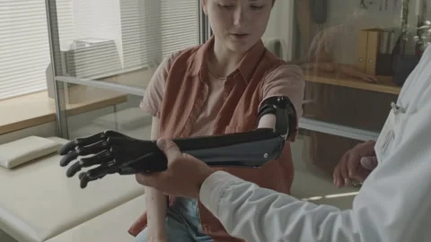 Prosthetist Fitting Bionic Arm to Female Patient Stock Footage 251877708