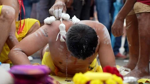 Prostrating devotee with back piercings at Thaipusam festival ritual Stock Footage 332736990
