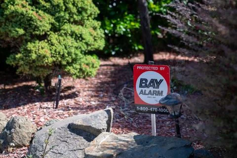 Protected by Bay Area alarm sign outside of home Stock Photos