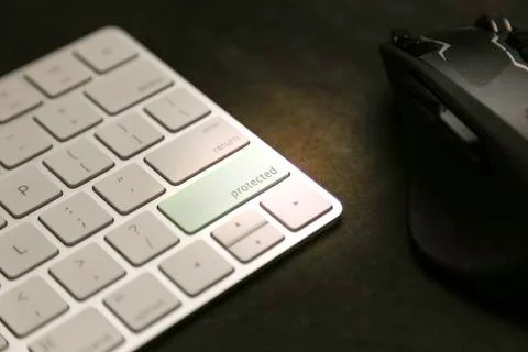 Protected written on keyboard key - data security and protection Stock Photos