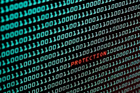 Protection text and binary code concept from the desktop screen, selective fo Stock Photos