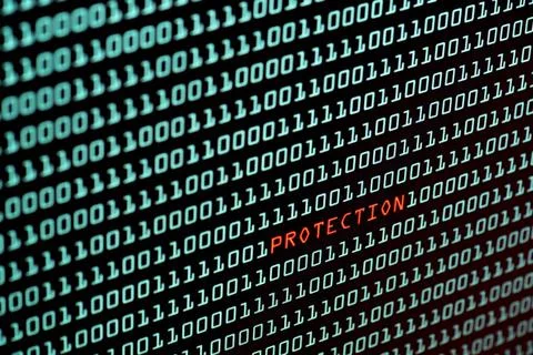 Protection text and binary code concept from the desktop screen, selective... Stock Photos