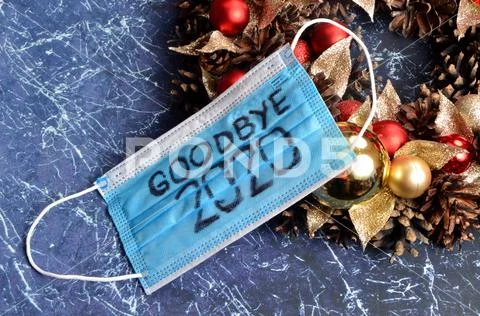 Protective blue face mask on Advent wreath. Text on the mask Goodbye 2020 Stock Photos