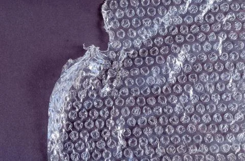 Protective bubble wrap on colored background. Texture of plastic wrap with ca Stock Photos