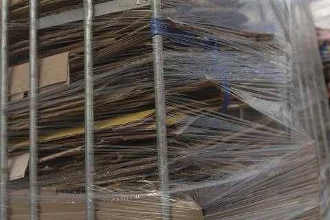 Protective coverings envelop items within mobile metal cage structure Stock Photos