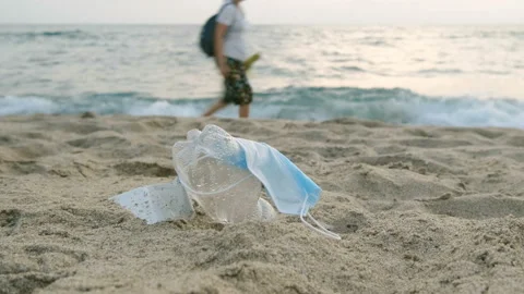 Protective face mask and plastic bottle discarded on marine ecosystem,pollution Video stock 161466722