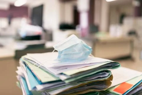 Protective face mask of paper work accumulation in pandemic years Stock-Fotos