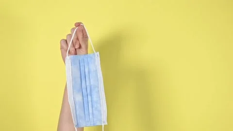 Protective face mask on yellow background. Stock Footage 147946667