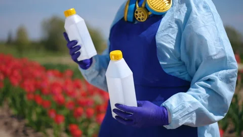 Protective Gear Essentials for Working in a Flower Field with Chemicals Stock Footage 306839110