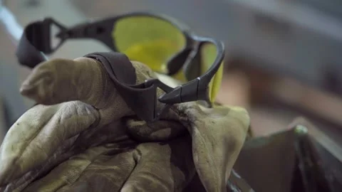 Protective gear on metal surface in workshop safety glasses and gloves Stock Footage 306179659