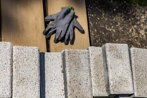 Protective gloves for a bricklayer, placed on a granite block, personal pro.. Stock Photos