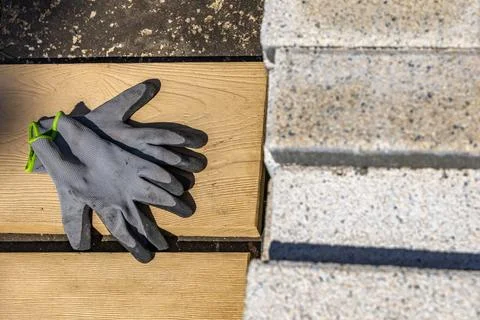 Protective gloves for a bricklayer, placed on a granite block, personal pro.. Stock Photos