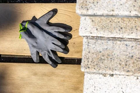 Protective gloves for a bricklayer, placed on a granite block, personal pro.. Stock Photos