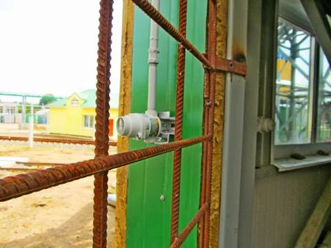 Protective grating on the window of an industrial building. Stock Photos