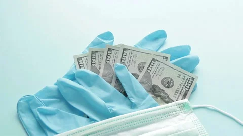 Protective mask dollar banknotes rubber gloves panning shot Stock Footage 126697961