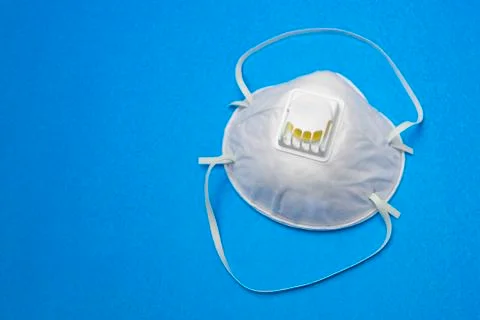 Protective mask with filter valve close-up on a blue background.Copy space. Foto stock