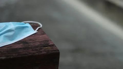 Protective mask on top of a bench Stock Footage 158586544