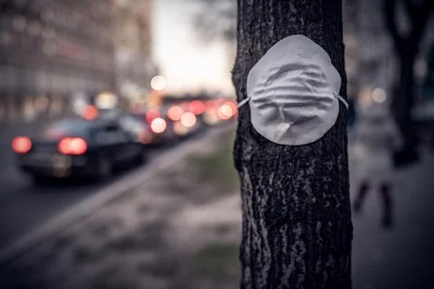 Protective mask on a tree in protest against the pollution level in large cities Stock Photos