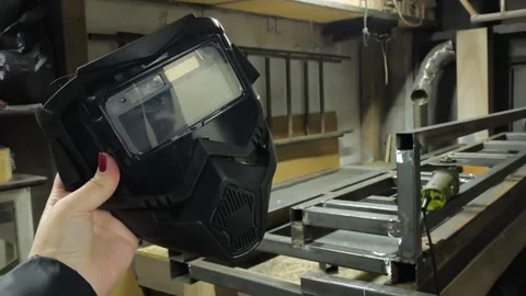 Protective mask for welding work in the hand against the background of metal Stock Footage 322733439