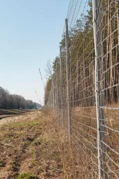Protective mesh on the side of road from wild animals Stock Photos