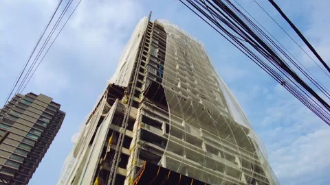 Protective nets from a building under construction sway in the wind Video stock 266085294