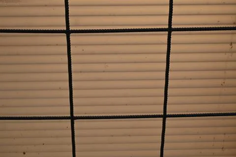 Protective netting over ribbed surface Stock Photos
