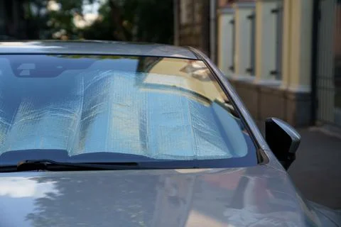 Protective reflective surface under windshield of car on hot day, heated by sun Stock Photos