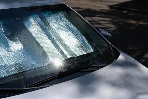 Protective reflective surface under windshield of car on hot day, heated by sun Stock Photos