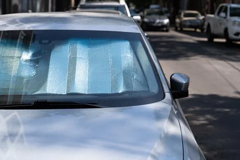Protective reflective surface under windshield of car on hot day, heated by sun Stock Photos