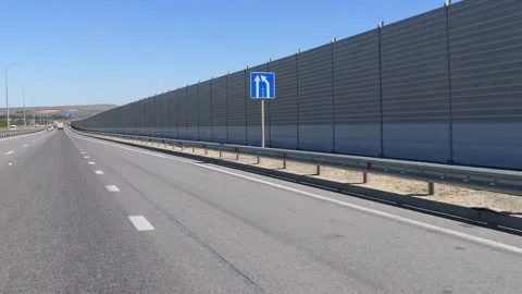 Protective screens along the freeway. Video shooting in motion, the effect of Stock Footage 237550838