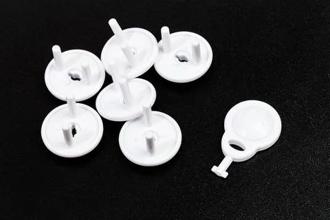 Protective Socket plugs on black  background  child safety Stock Photos