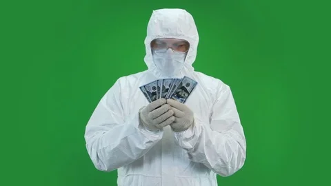 In a protective suit counts money Stock Footage 127240160
