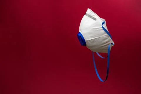 Protective surgical face mask on the red background. Stock Photos