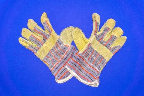 Protective worker gloves on a blue background Foto stock