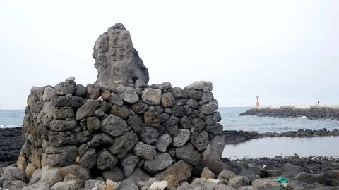 " Protector tower " In korean, this rock is on the coast of Jeju island Stock Footage 105579060
