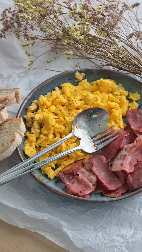 Protein breakfast with scrambled eggs, bacon, bread and coffee Stock Footage 340331198