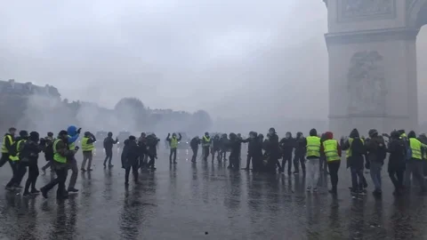 Protest at Arc de Triomphe famous landmark in Paris, France with tear gases Stock Footage 103183571